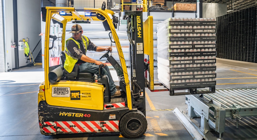 Man driving forklift in a warehouse